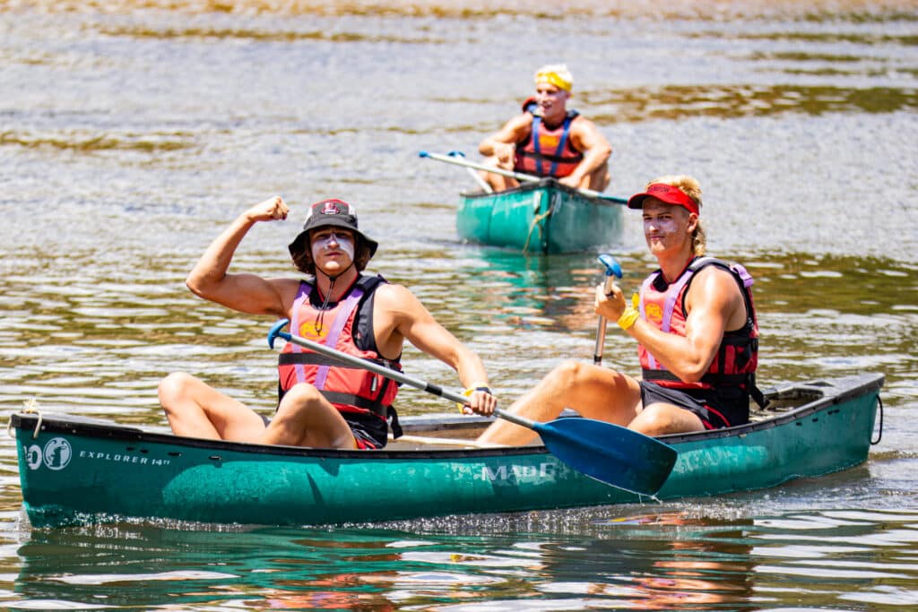 A sports team taking part in PGL's canoeing activity.