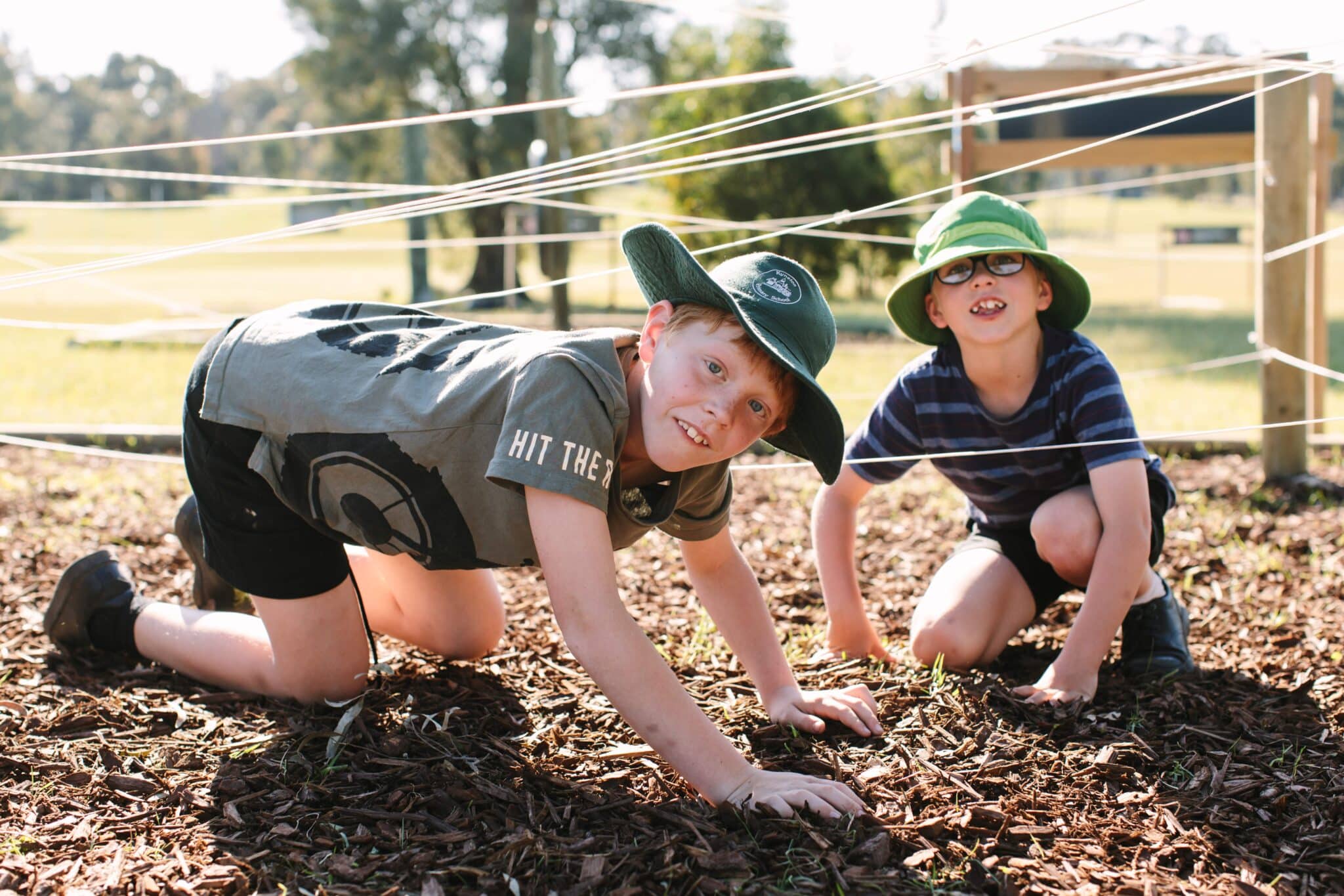 Two children taking part in a challenge course activity at PGL camp